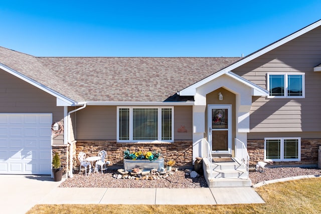 view of front of home featuring concrete driveway, a garage, stone siding, and a shingled roof