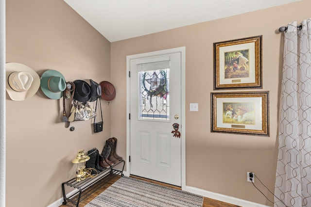 entryway featuring wood finished floors and baseboards