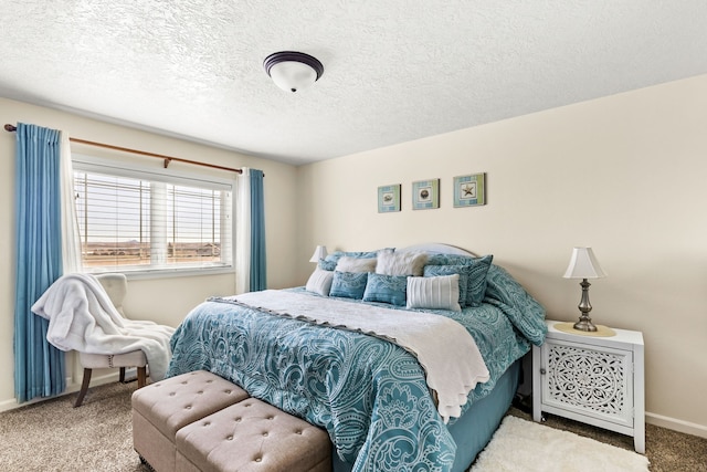 bedroom with carpet flooring, a textured ceiling, and baseboards