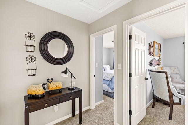 hall with baseboards and carpet floors