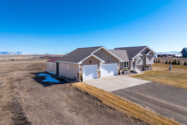 view of front of house with concrete driveway, roof with shingles, a front yard, covered porch, and a garage