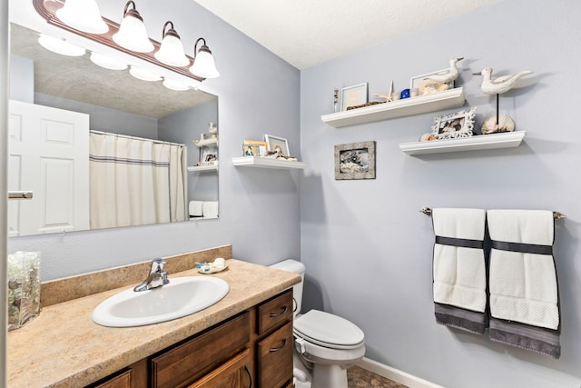 full bath featuring vanity, a shower with curtain, baseboards, a textured ceiling, and toilet
