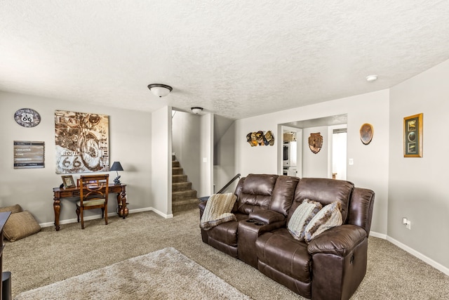 carpeted living area with stairway, baseboards, and a textured ceiling