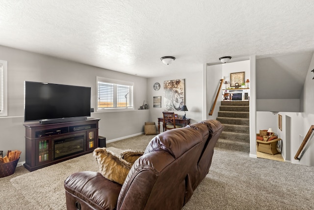 carpeted living room featuring a textured ceiling, stairs, and baseboards