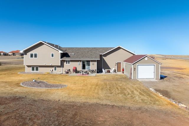 exterior space featuring driveway, a yard, a shingled roof, a garage, and a patio area