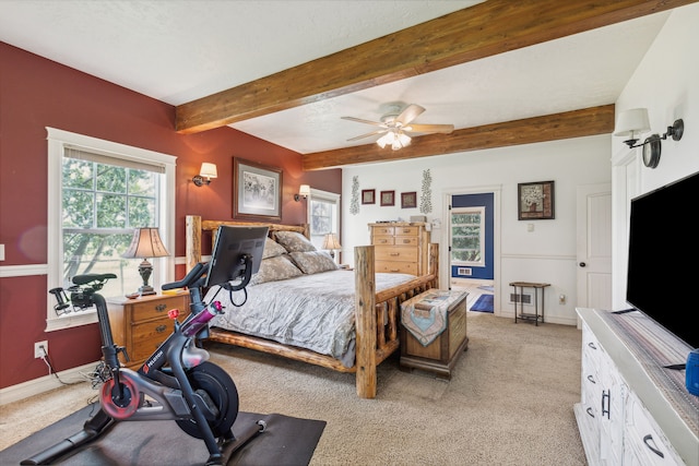 bedroom featuring light carpet, beam ceiling, baseboards, and a ceiling fan