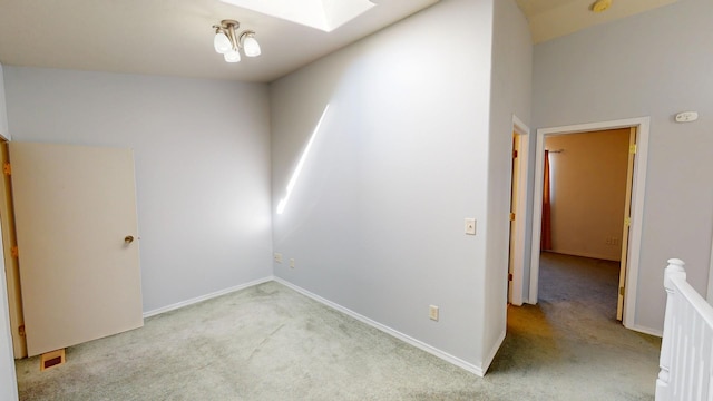 103 Alice Ave Unit B, Hamilton, MT 59840 - carpeted spare room featuring a skylight and baseboards