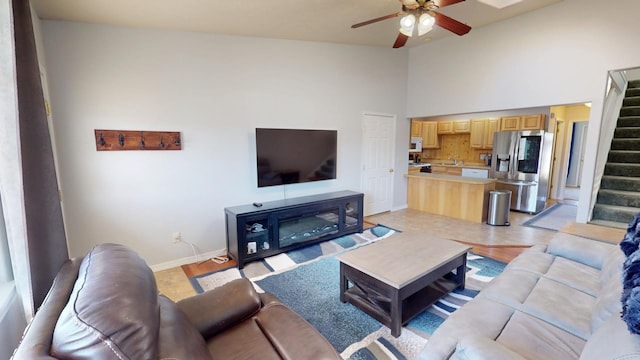 103 Alice Ave Unit B, Hamilton, MT 59840 - living room with ceiling fan, stairway, light wood-style floors, and high vaulted ceiling