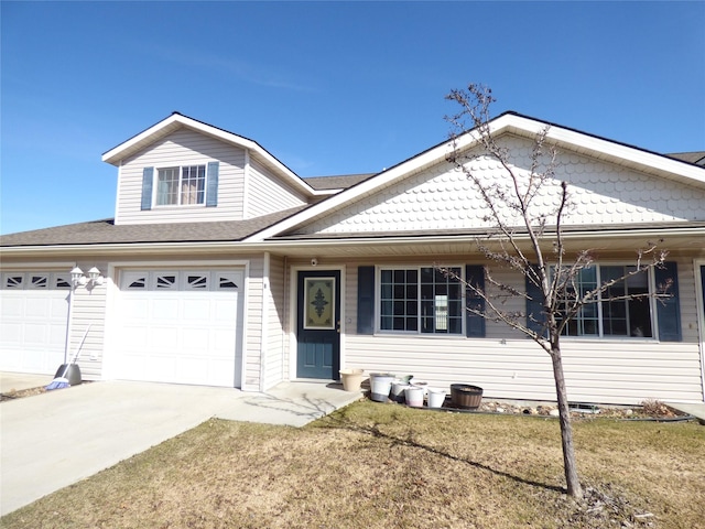103 Alice Ave Unit B, Hamilton, MT 59840 - view of front of house with concrete driveway, a front lawn, an attached garage, and a shingled roof