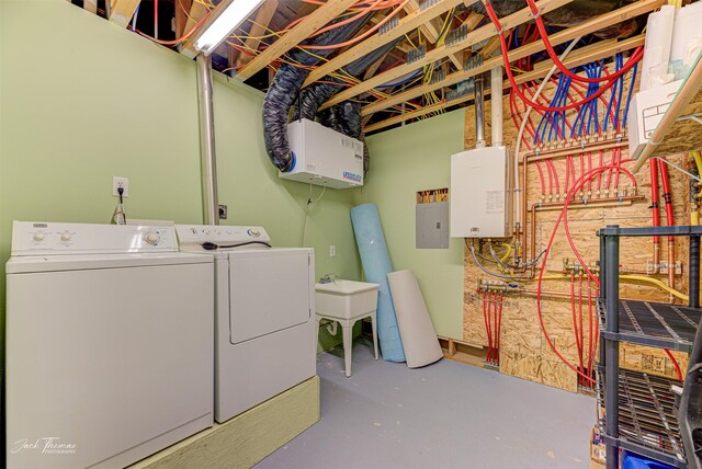 washroom featuring electric panel, laundry area, independent washer and dryer, and a sink