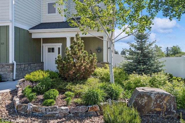 113 Mountain Vista Ct, Kalispell, MT 59901 - property entrance with a shingled roof, stone siding, and board and batten siding