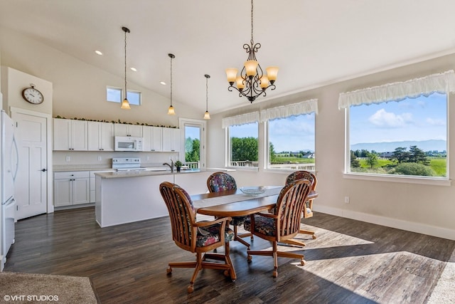 113 Mountain Vista Ct, Kalispell, MT 59901 - dining area with a chandelier, recessed lighting, dark wood-style flooring, baseboards, and high vaulted ceiling
