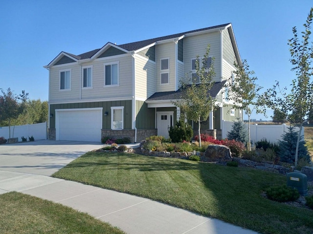 113 Mountain Vista Ct, Kalispell, MT 59901 - view of front of property featuring a garage, stone siding, concrete driveway, and board and batten siding