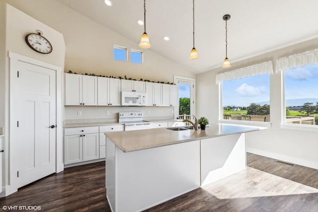 113 Mountain Vista Ct, Kalispell, MT 59901 - kitchen with white appliances, white cabinets, light countertops, dark wood-style flooring, and recessed lighting