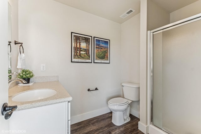 113 Mountain Vista Ct, Kalispell, MT 59901 - bathroom featuring vanity, wood finished floors, toilet, a shower stall, and baseboards