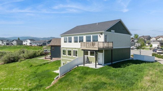 113 Mountain Vista Ct, Kalispell, MT 59901 - rear view of property featuring a residential view, a yard, a wooden deck, and a shingled roof
