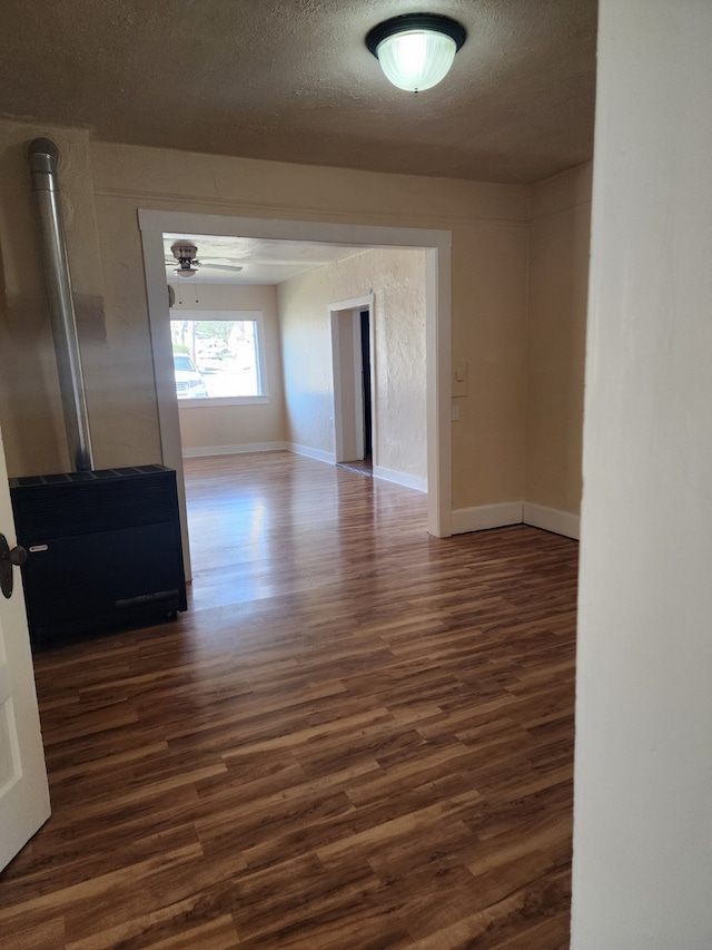 406 W 1st St W, Whitehall, MT 59759 - empty room with a textured ceiling, dark wood-type flooring, baseboards, and a ceiling fan