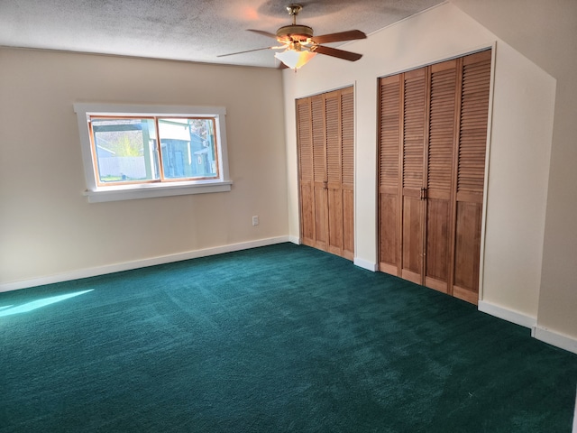 406 W 1st St W, Whitehall, MT 59759 - unfurnished bedroom featuring dark carpet, two closets, a textured ceiling, baseboards, and ceiling fan
