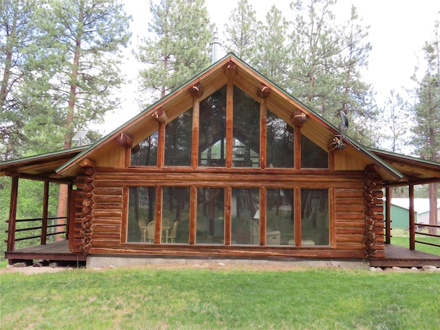 807 Pheasant Run, Hamilton, MT 59840 - back of property with log exterior, a wooden deck, and a lawn