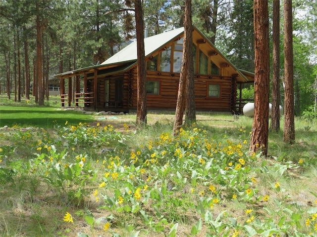 807 Pheasant Run, Hamilton, MT 59840 - view of side of property with log exterior and metal roof