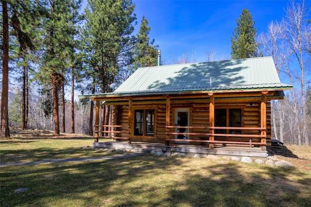 807 Pheasant Run, Hamilton, MT 59840 - log home featuring log siding, a front lawn, and metal roof