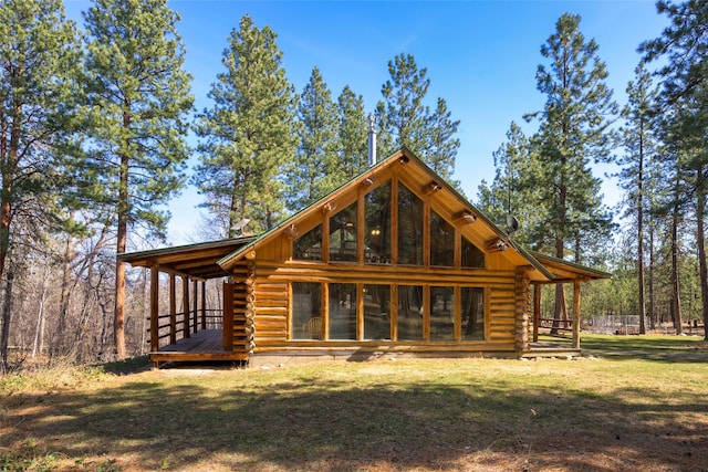 807 Pheasant Run, Hamilton, MT 59840 - rear view of house with log siding, a yard, and a wooden deck