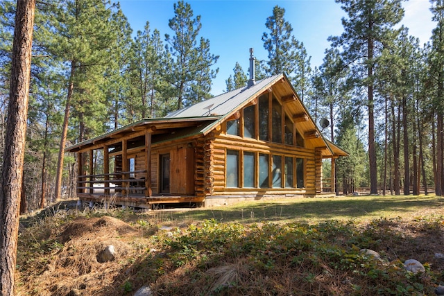 807 Pheasant Run, Hamilton, MT 59840 - cabin with log siding, a wooden deck, and metal roof