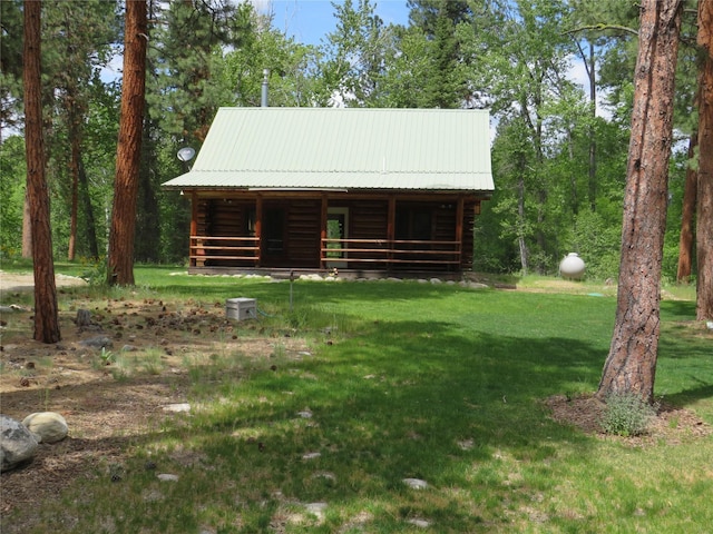 807 Pheasant Run, Hamilton, MT 59840 - cabin with log exterior, metal roof, and a front yard