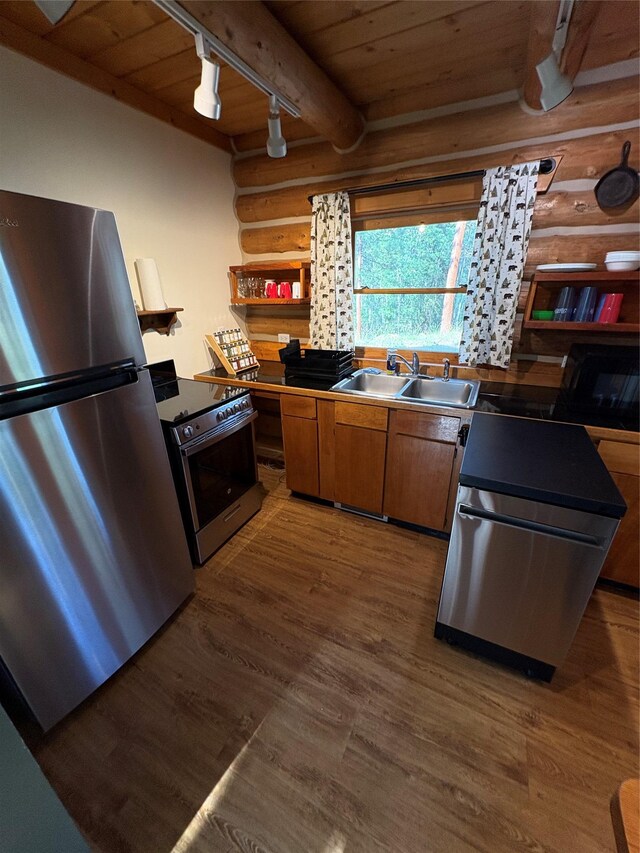 807 Pheasant Run, Hamilton, MT 59840 - kitchen with stainless steel appliances, track lighting, a sink, wooden ceiling, and log walls