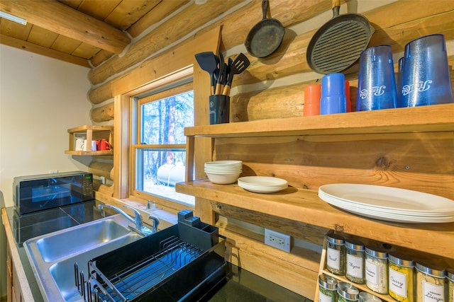 807 Pheasant Run, Hamilton, MT 59840 - kitchen with log walls, wooden ceiling with exposed beams, and open shelves