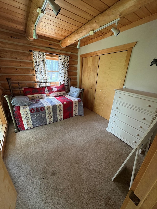 807 Pheasant Run, Hamilton, MT 59840 - carpeted bedroom with wooden ceiling with exposed beams, rustic walls, and a closet