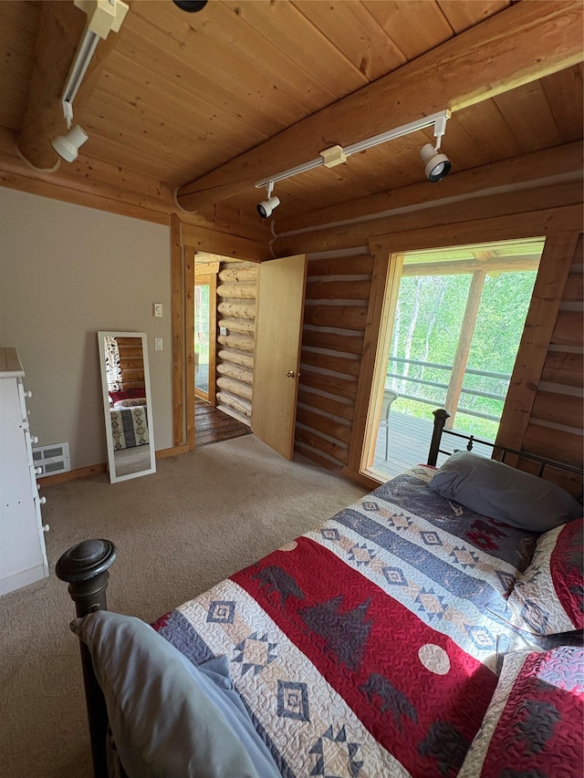 807 Pheasant Run, Hamilton, MT 59840 - bedroom with wooden ceiling with exposed beams, carpet floors, log walls, and track lighting