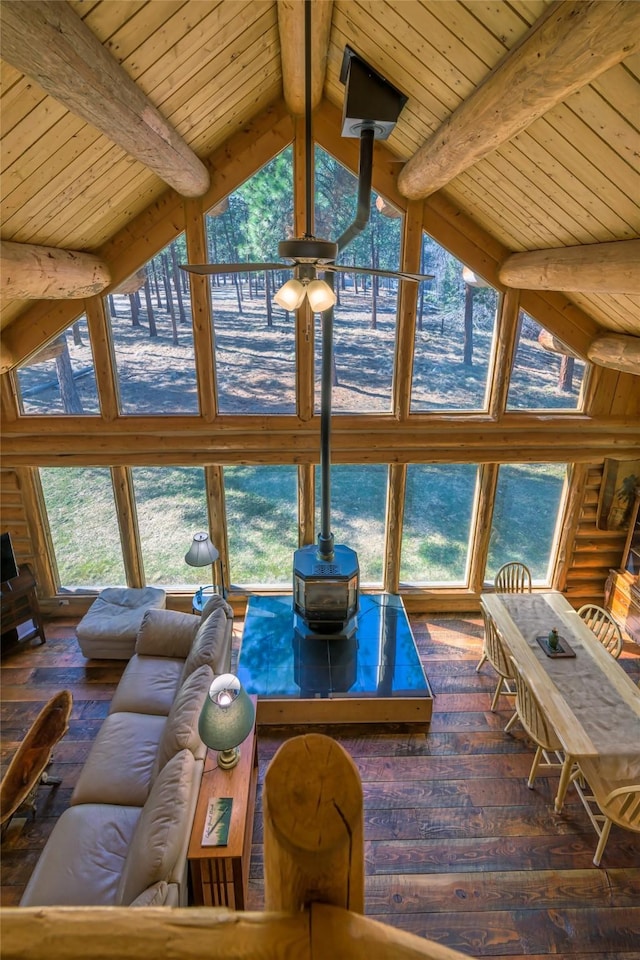 807 Pheasant Run, Hamilton, MT 59840 - living area featuring wooden ceiling with exposed beams, high vaulted ceiling, hardwood / wood-style floors, a ceiling fan, and a wood stove