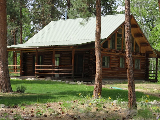 807 Pheasant Run, Hamilton, MT 59840 - view of front of property featuring log siding, metal roof, and a front lawn