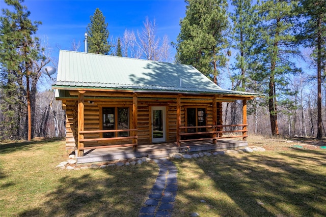 807 Pheasant Run, Hamilton, MT 59840 - log-style house with metal roof, a front lawn, log exterior, and a porch
