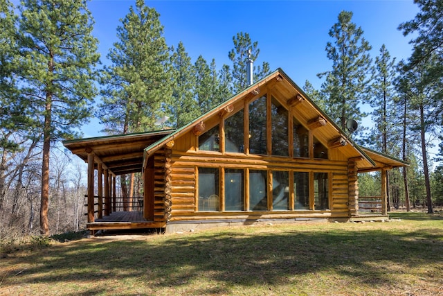 807 Pheasant Run, Hamilton, MT 59840 - back of house featuring log exterior and a lawn