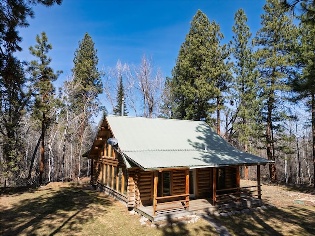807 Pheasant Run, Hamilton, MT 59840 - log cabin with log siding, a porch, and metal roof