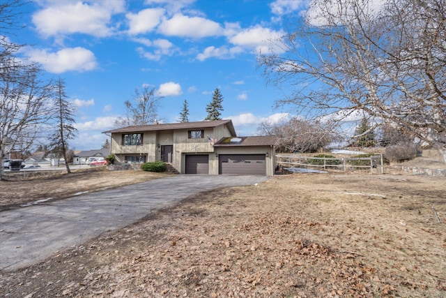 view of front of home with driveway and a garage