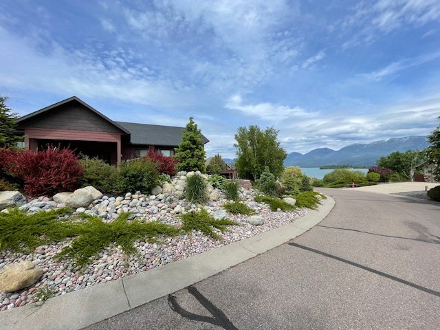 113 Mission Bay Dr, Polson, MT 59860 - view of property exterior featuring a water and mountain view and an attached garage