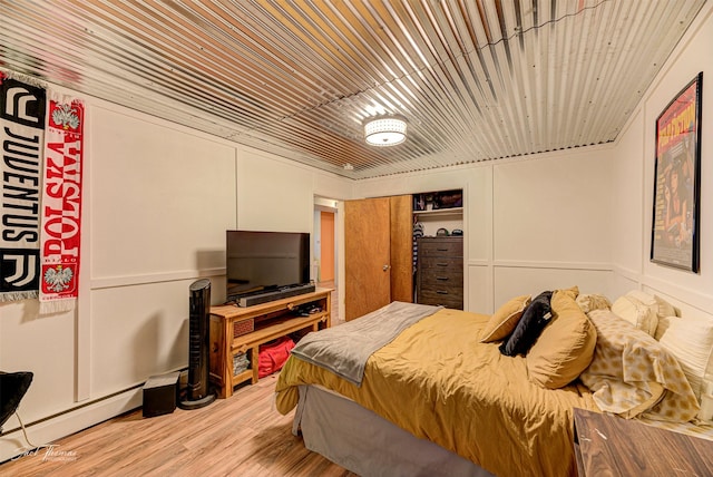 4212 W US Highway 12, Helena, MT 59601 - bedroom with baseboard heating, wood finished floors, and a closet