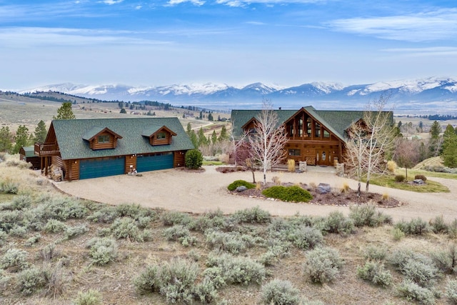 1130 Hegson Dr, Stevensville, MT 59870 - view of front facade with a mountain view, driveway, and a garage