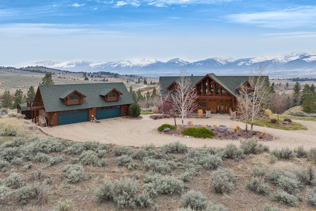 1130 Hegson Dr, Stevensville, MT 59870 - view of front of home featuring a mountain view, dirt driveway, and log siding