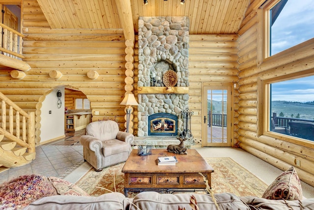 1130 Hegson Dr, Stevensville, MT 59870 - living room featuring wood ceiling, rustic walls, a stone fireplace, and healthy amount of natural light