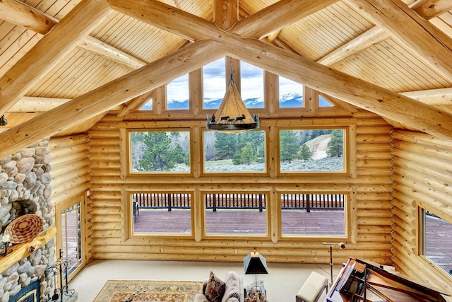 1130 Hegson Dr, Stevensville, MT 59870 - carpeted living area with rustic walls, a high ceiling, and wooden ceiling with exposed beams