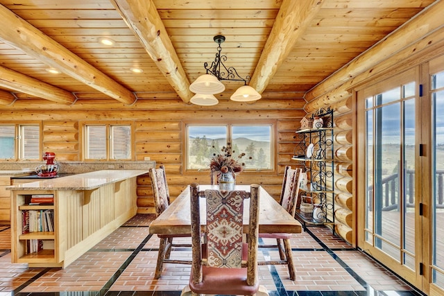 1130 Hegson Dr, Stevensville, MT 59870 - dining space featuring wood ceiling with exposed beams, brick floors, a chandelier, recessed lighting, and rustic walls
