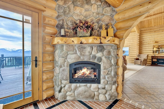 1130 Hegson Dr, Stevensville, MT 59870 - detailed view of log walls, a mountainous background, and a stone fireplace