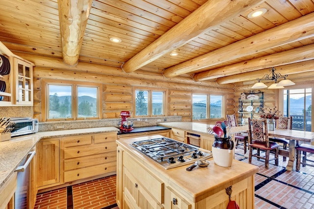1130 Hegson Dr, Stevensville, MT 59870 - kitchen featuring appliances with stainless steel finishes, wood ceiling with exposed beams, brick patterned floors, light brown cabinetry, and plenty of natural light