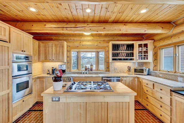 1130 Hegson Dr, Stevensville, MT 59870 - kitchen with light brown cabinets, stainless steel appliances, a center island, wood ceiling with exposed beams, and a sink