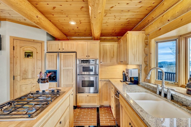 1130 Hegson Dr, Stevensville, MT 59870 - kitchen featuring light brown cabinetry, a sink, stainless steel appliances, brick patterned flooring, and wooden ceiling with exposed beams