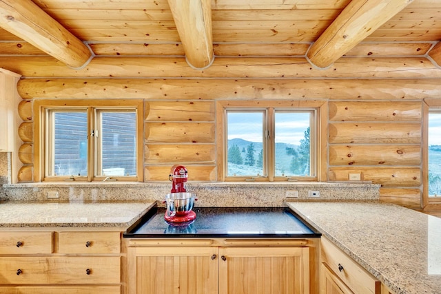 1130 Hegson Dr, Stevensville, MT 59870 - kitchen featuring wood ceiling with exposed beams, rustic walls, light brown cabinets, and light stone countertops